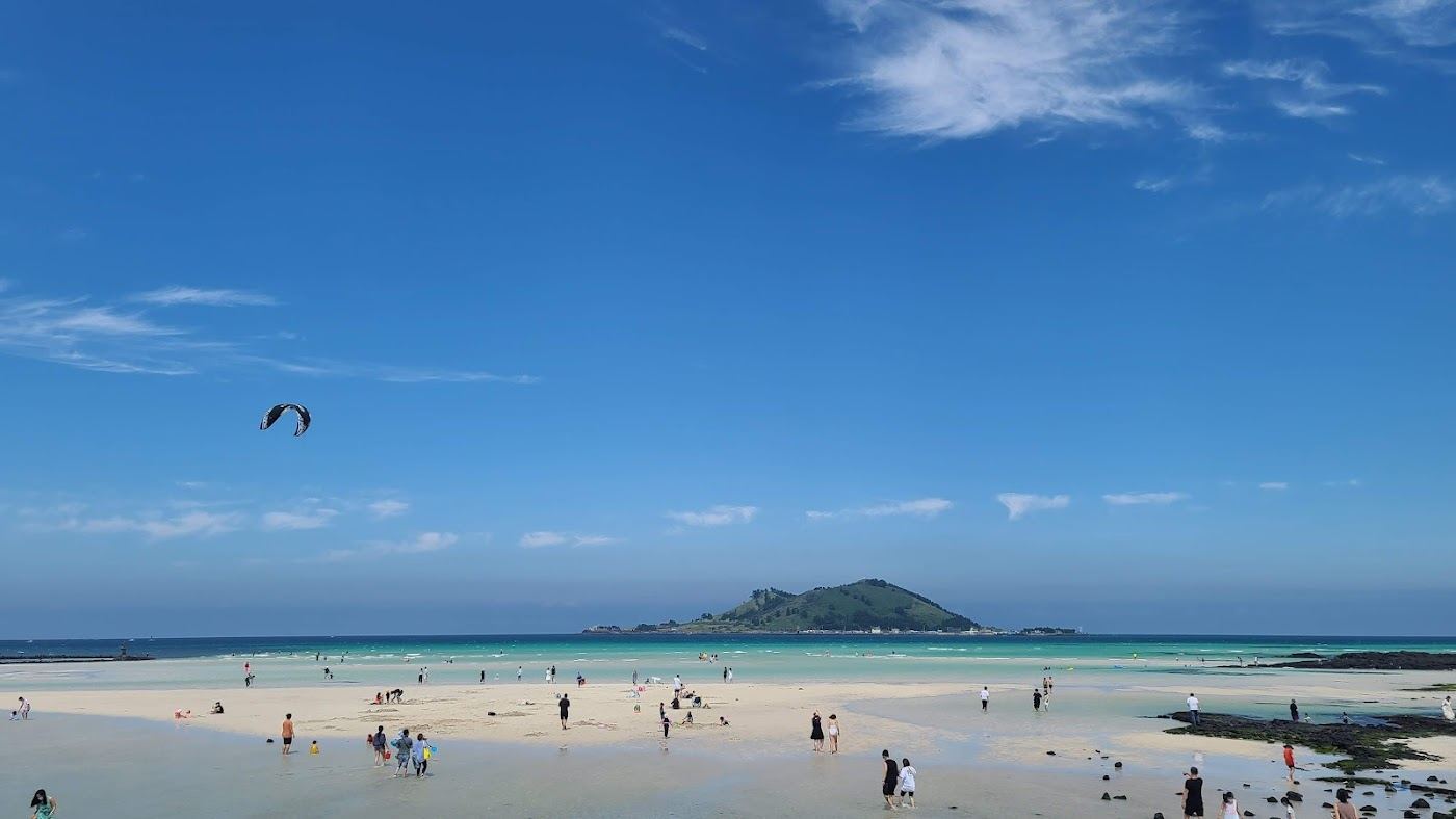 White shell sand and turquoise shallows facing Biyangdo island at Geumneung Beach on Jeju