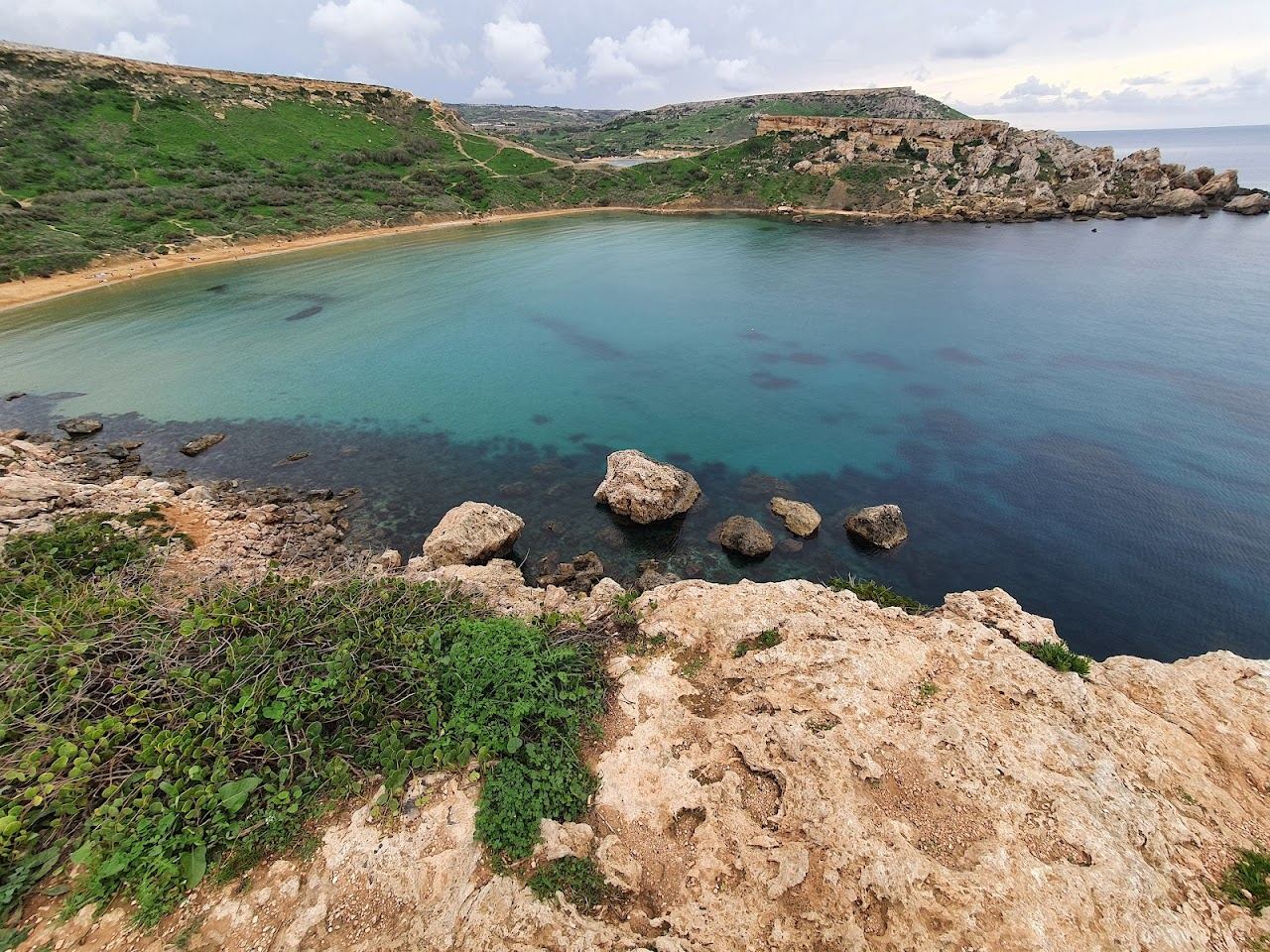 The reddish gold sand and clay cliffs of Ghajn Tuffieha Bay on the northwest coast of Malta