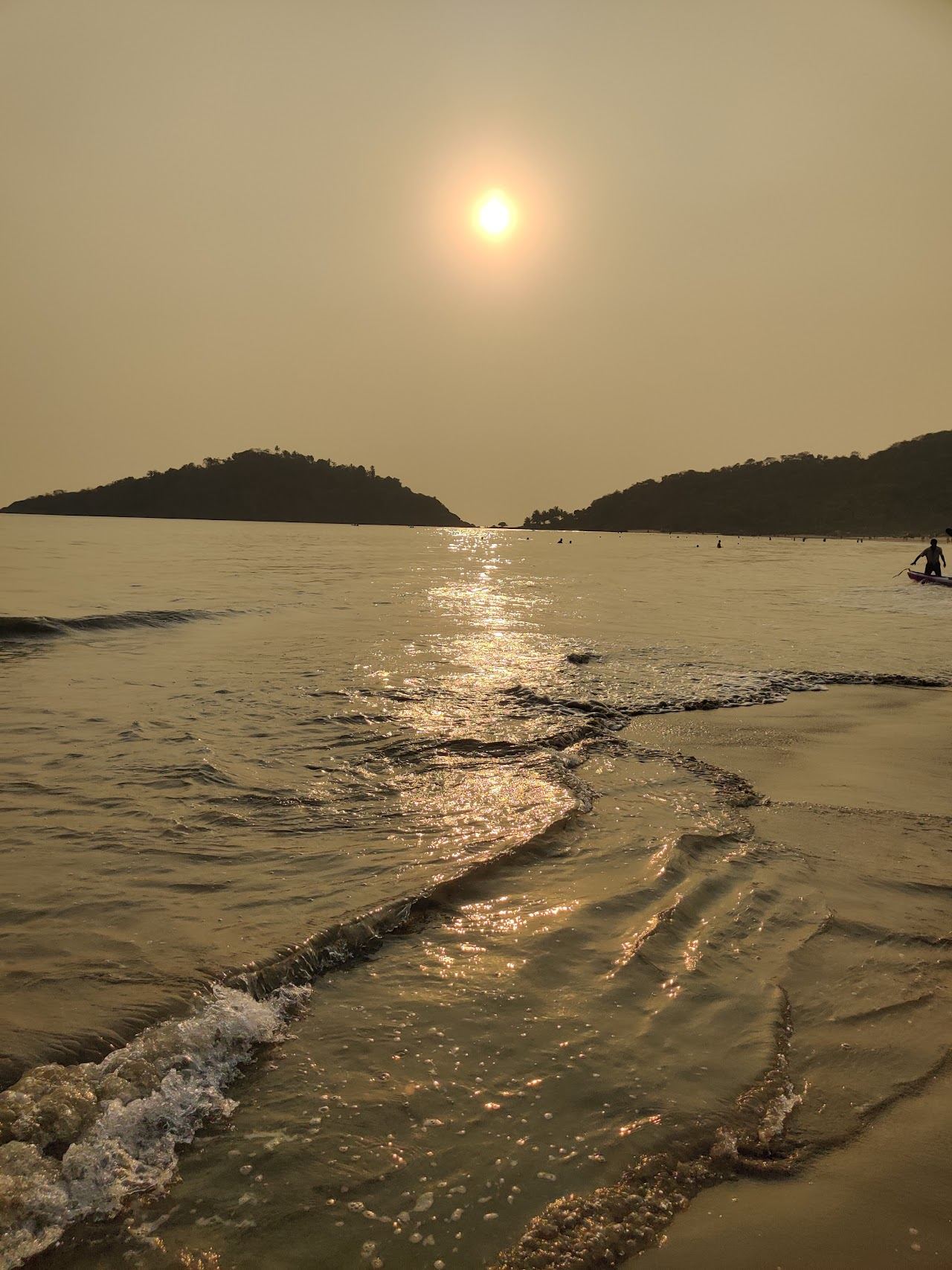 Calm clear water and palms at Palolem bay in south Goa