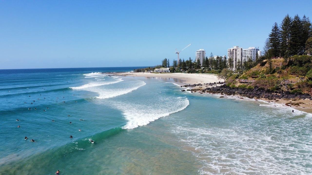 The sheltered curve of golden sand below Greenmount headland at Coolangatta