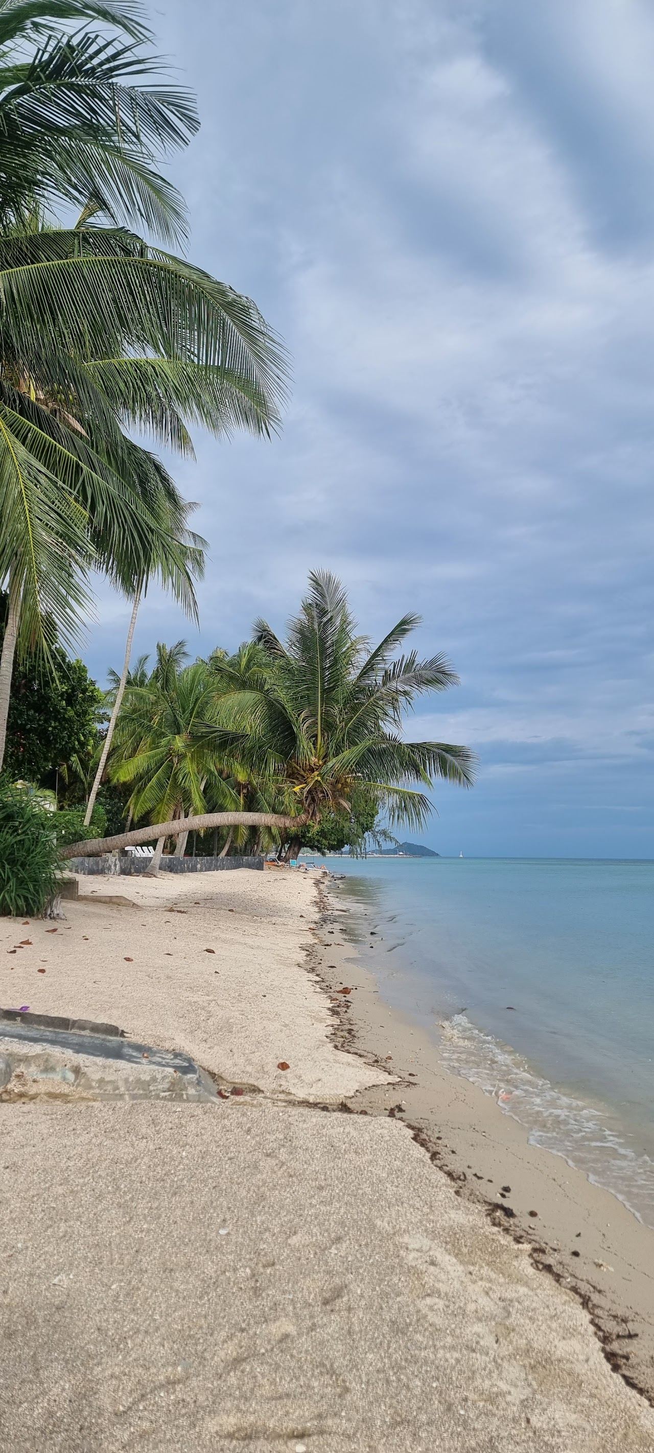 Shallow calm water and sand along Ban Tai beach on the south coast of Koh Phangan
