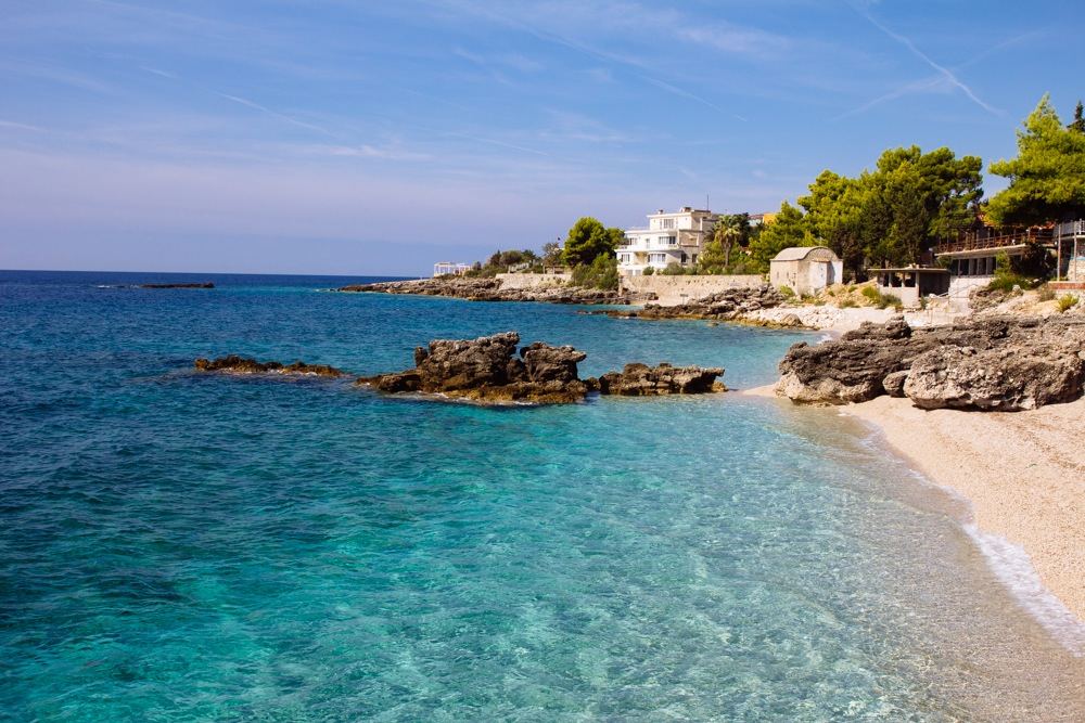 White pebble beach and clear turquoise Ionian water along the Dhermi shore on the Albanian Riviera
