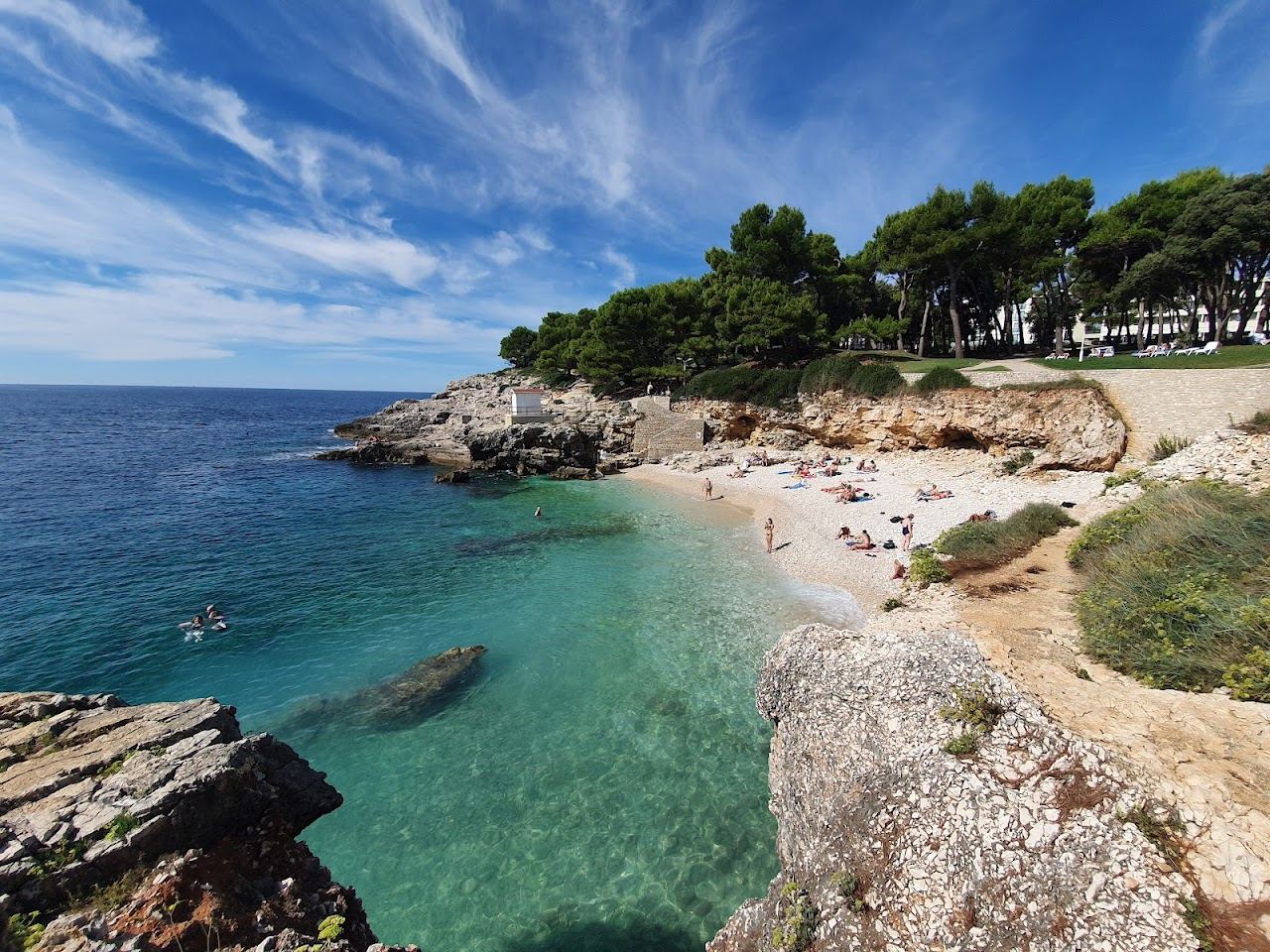 Turquoise water and white pebble at Hawaii beach on the Verudela peninsula near Pula