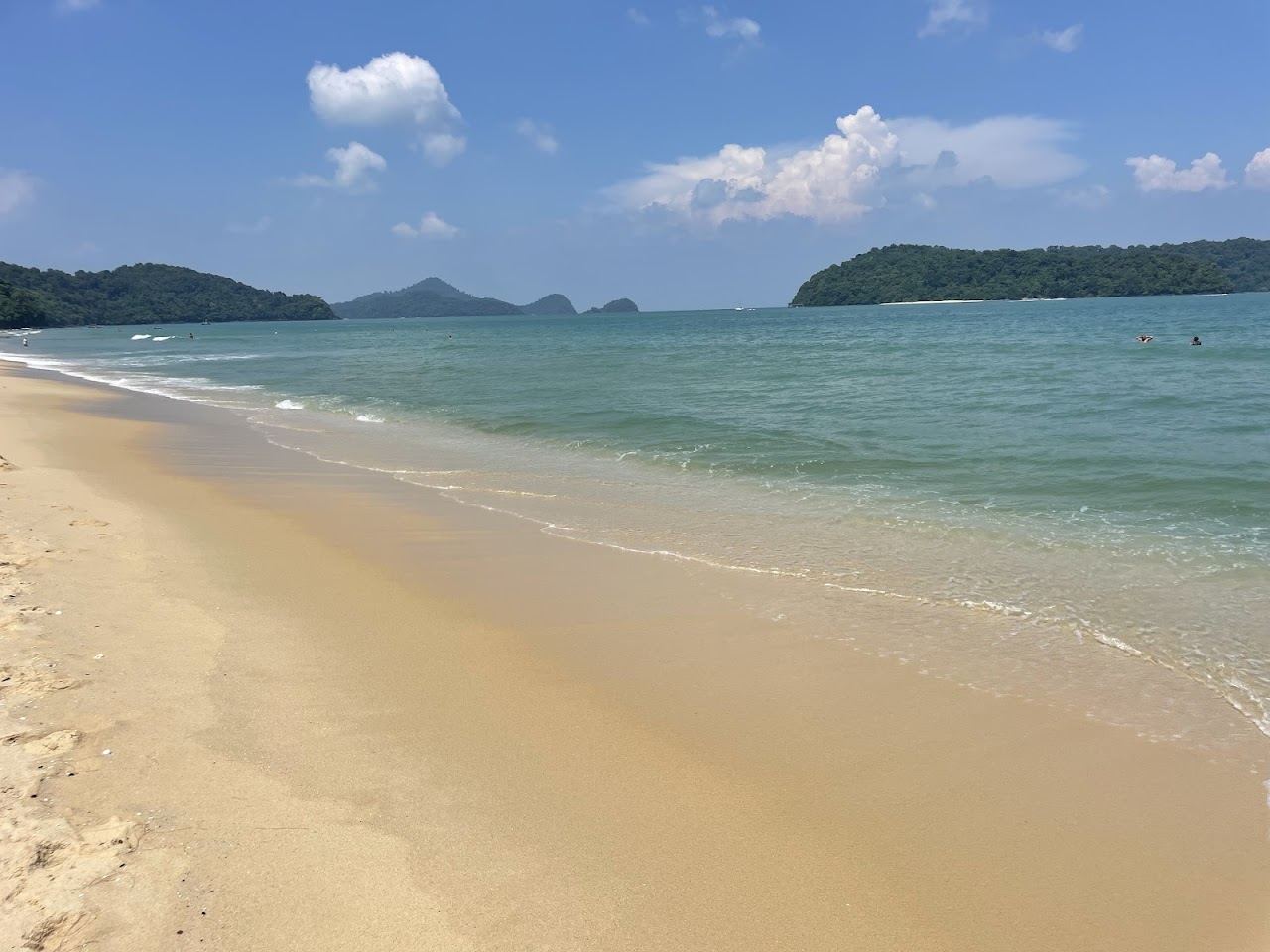 White sand and calm water along Pantai Tengah beach in front of the resort strip