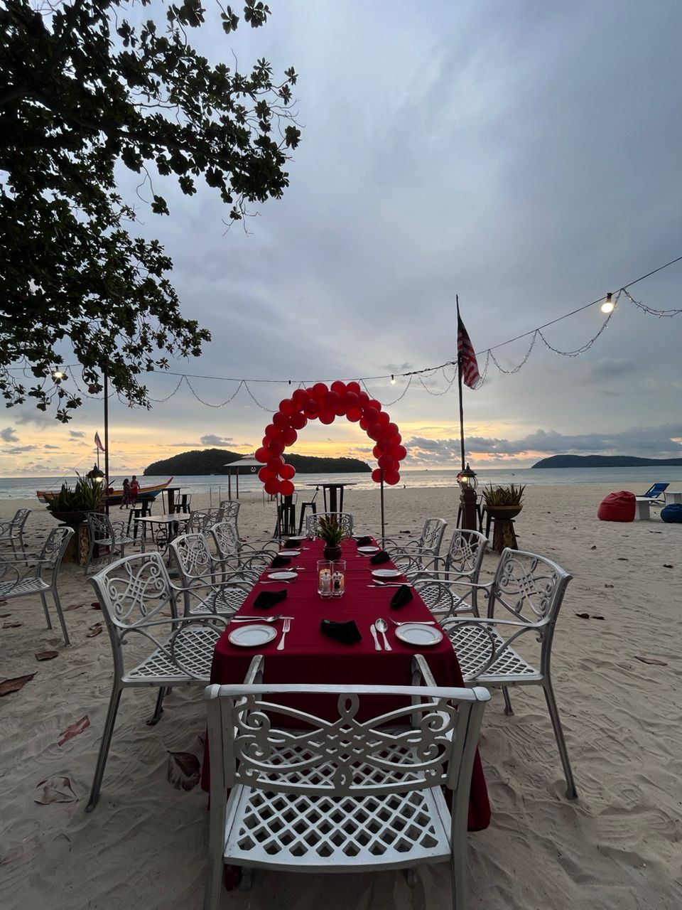 Tables and palms at Tropical Beach Bar on the sand at Holiday Villa in Langkawi
