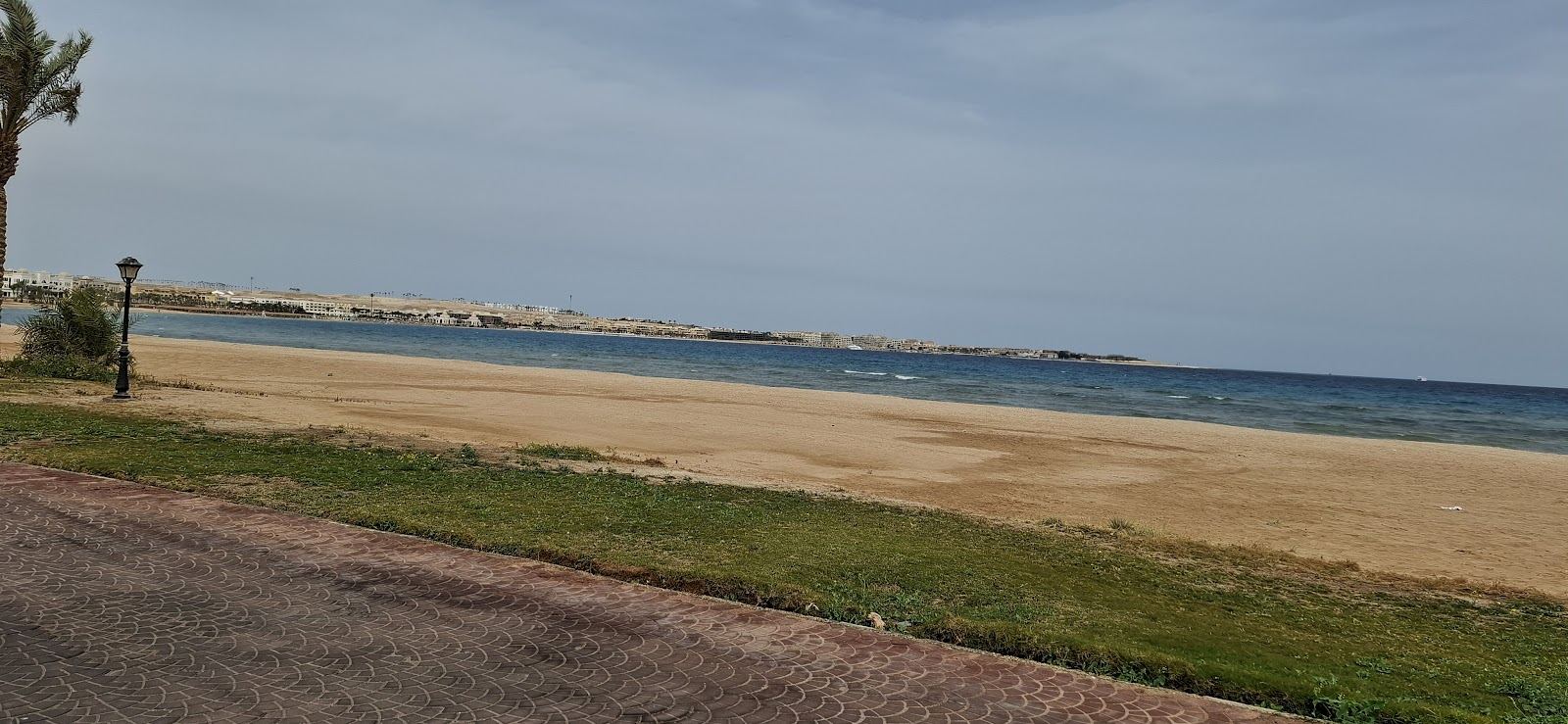 The calm bay and long marble promenade at Sahl Hasheesh near Hurghada in soft evening light