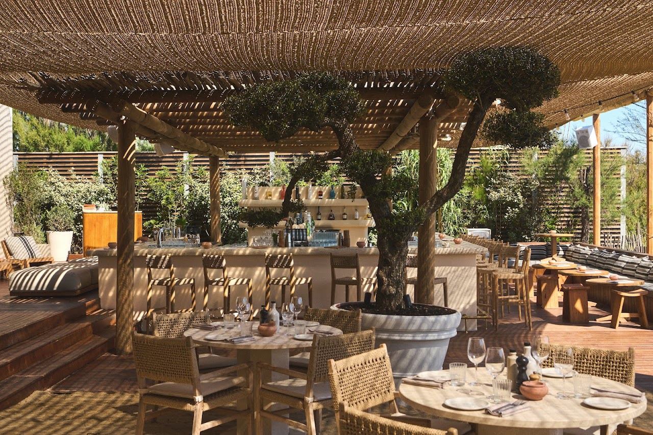 Driftwood styled loungers and parasols of Indie Beach on the sand at the southern end of Pampelonne near Ramatuelle