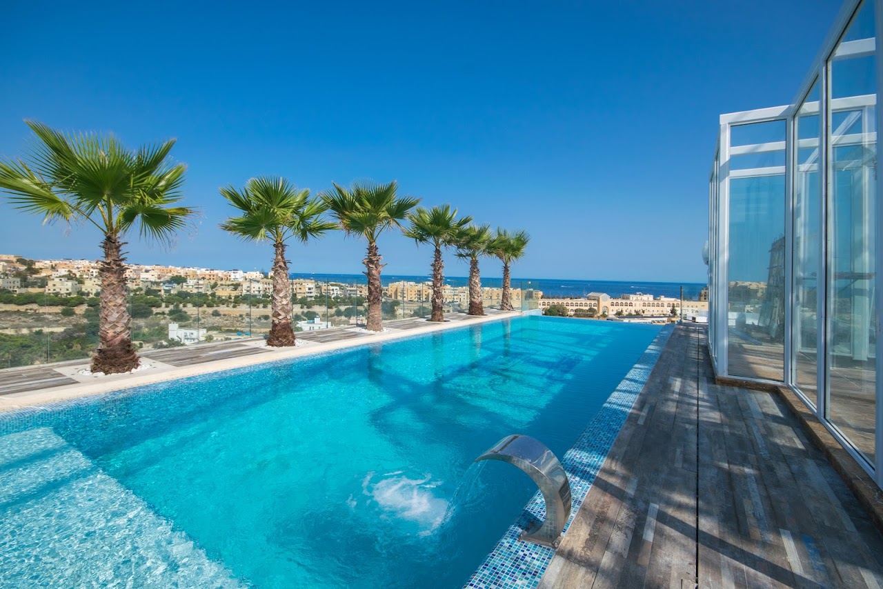 The rooftop infinity pool and loungers at Infinity by Hugo's above St Julian's, Malta, with the sea beyond