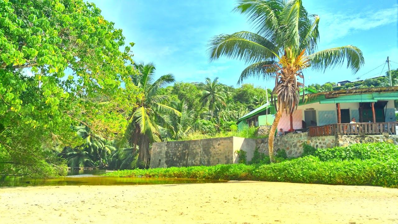 The small granite boulder cove and clear water of Anse Soleil on southwest Mahe