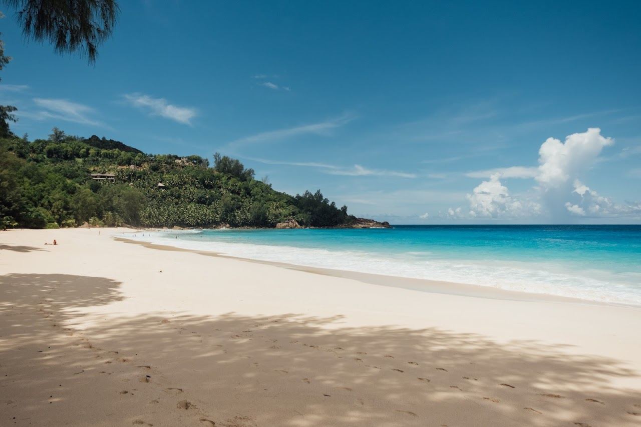 Open ocean swell rolling onto the wide wild sand of Anse Intendance on south Mahe