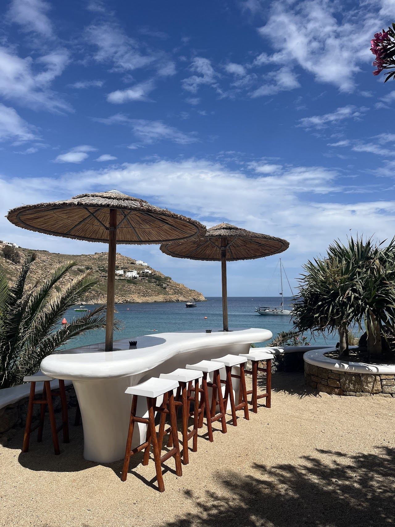 Loungers and turquoise water below Jackie O' Beach Club on Super Paradise bay in Mykonos