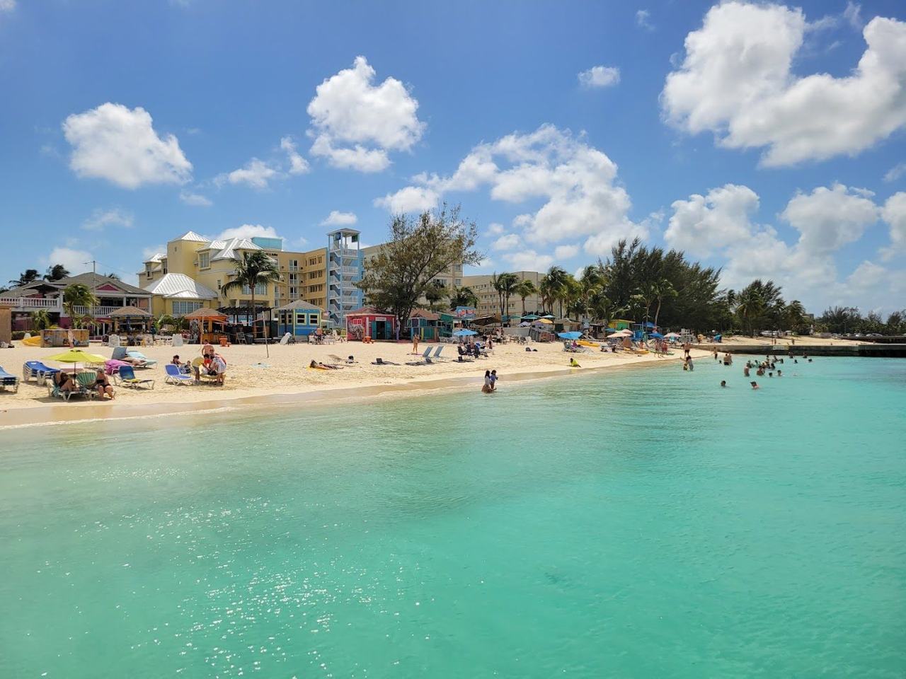 Lively shoreline and clear shallow water at Junkanoo Beach near the Nassau cruise port