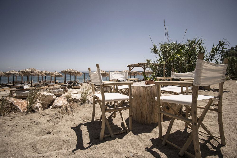 Cabana loungers and umbrellas on the sand of the sheltered Kalami cove near Kallithea on the east coast of Rhodes