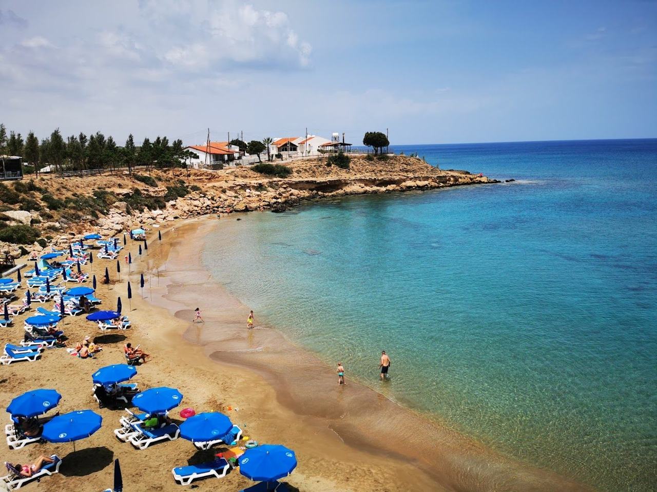 Calm turquoise water in a sheltered Kapparis cove framed by low rock near Paralimni on the southeast coast of Cyprus
