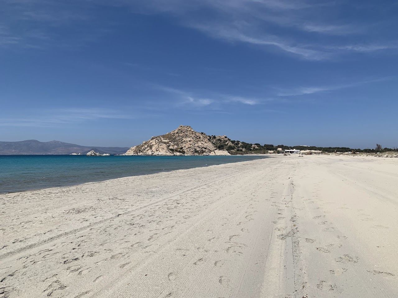 The long quiet white sand and clear water of Kastraki beach in Naxos