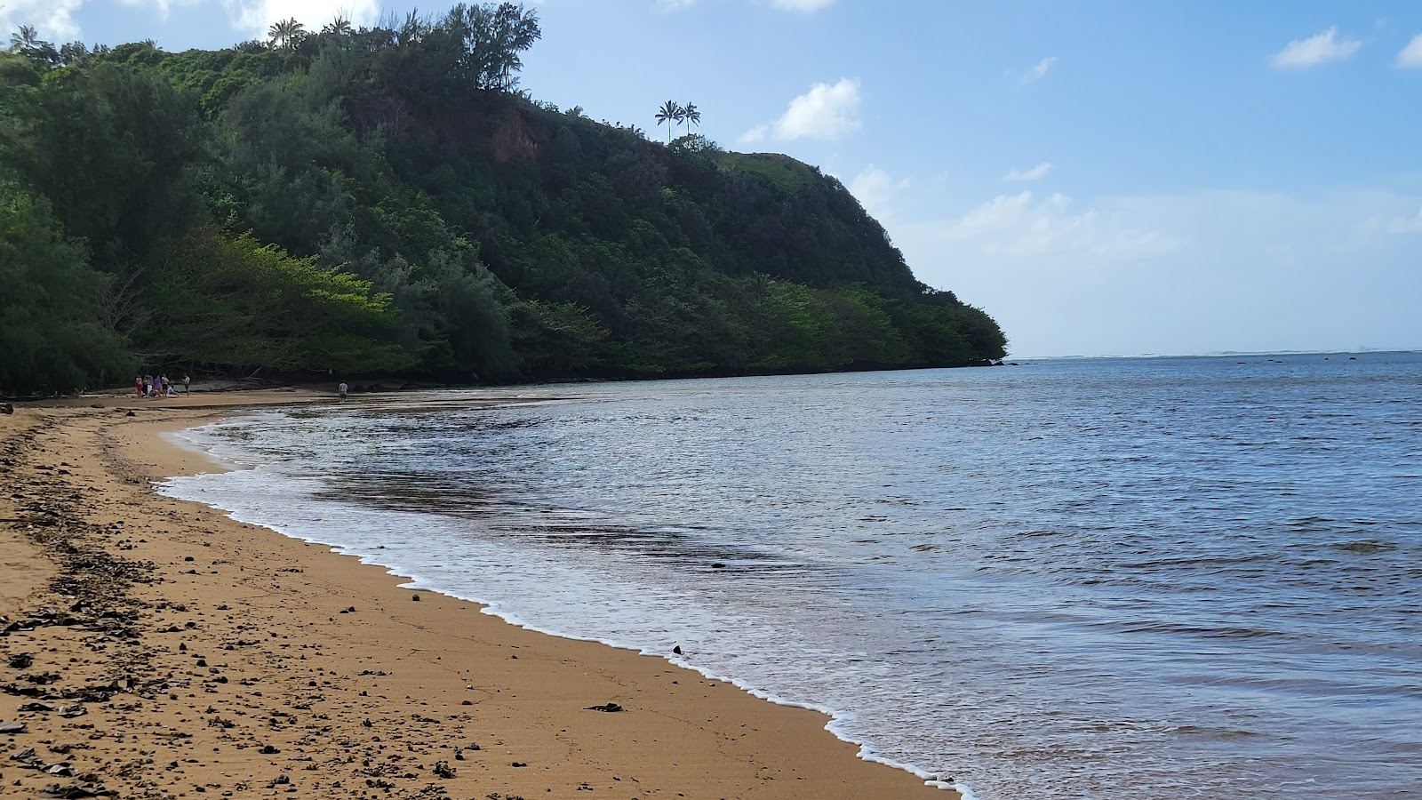 Flat, clear, reef sheltered water over a shallow sandy lagoon on the coast of Kauai