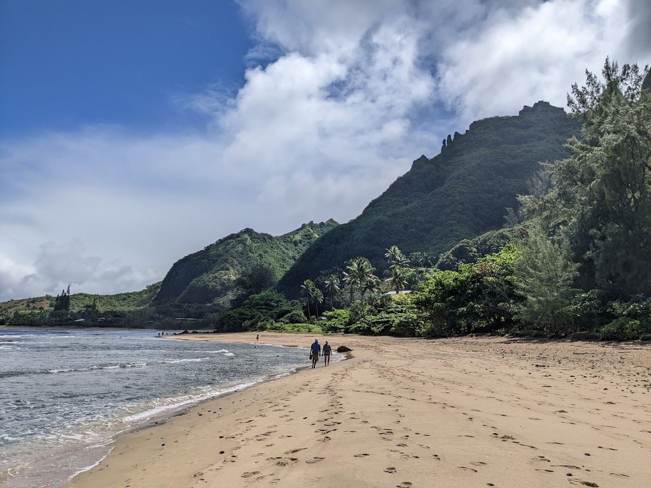 Reef lagoon and golden sand below the Napali cliffs at Kee Beach on Kauai