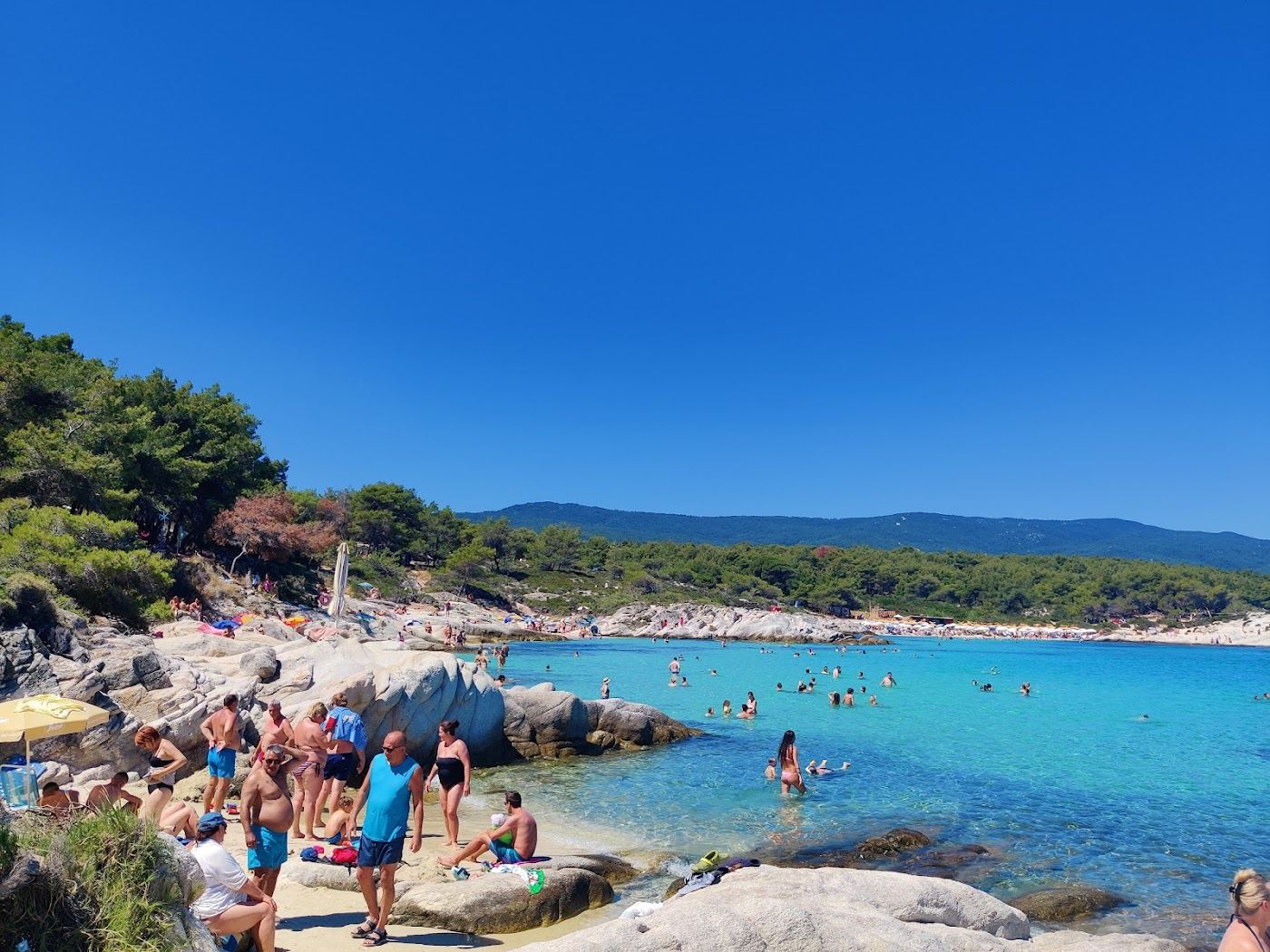 Sculpted white rock and clear turquoise coves at Kavourotrypes beach on Sithonia in Halkidiki