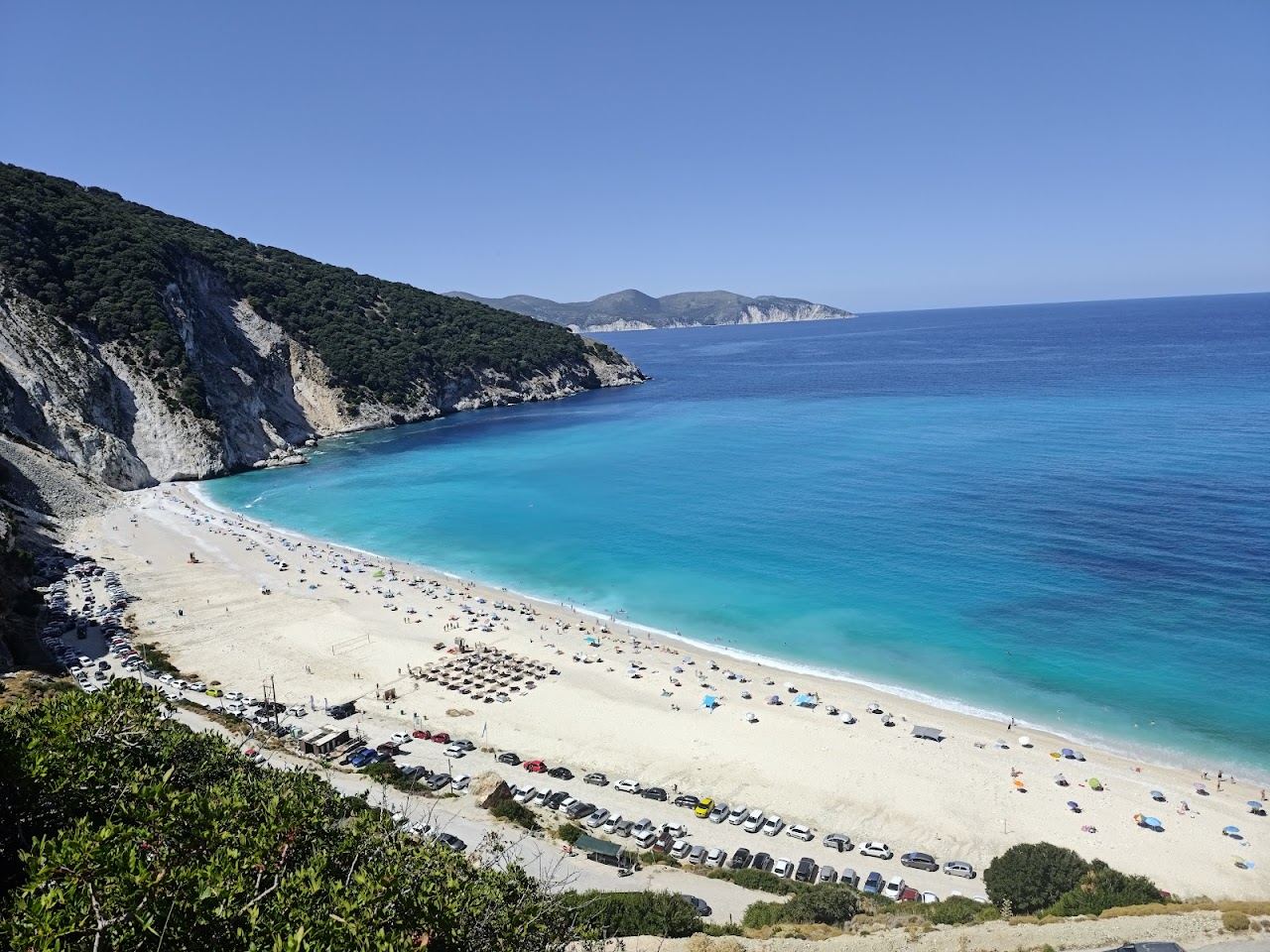 The white pebbles and turquoise water of Myrtos Beach beneath cliffs in Kefalonia