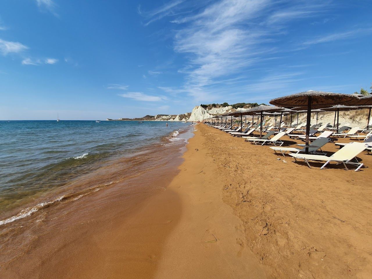 The unusual red clay sand and shallow water of Xi Beach on the Paliki peninsula of Kefalonia
