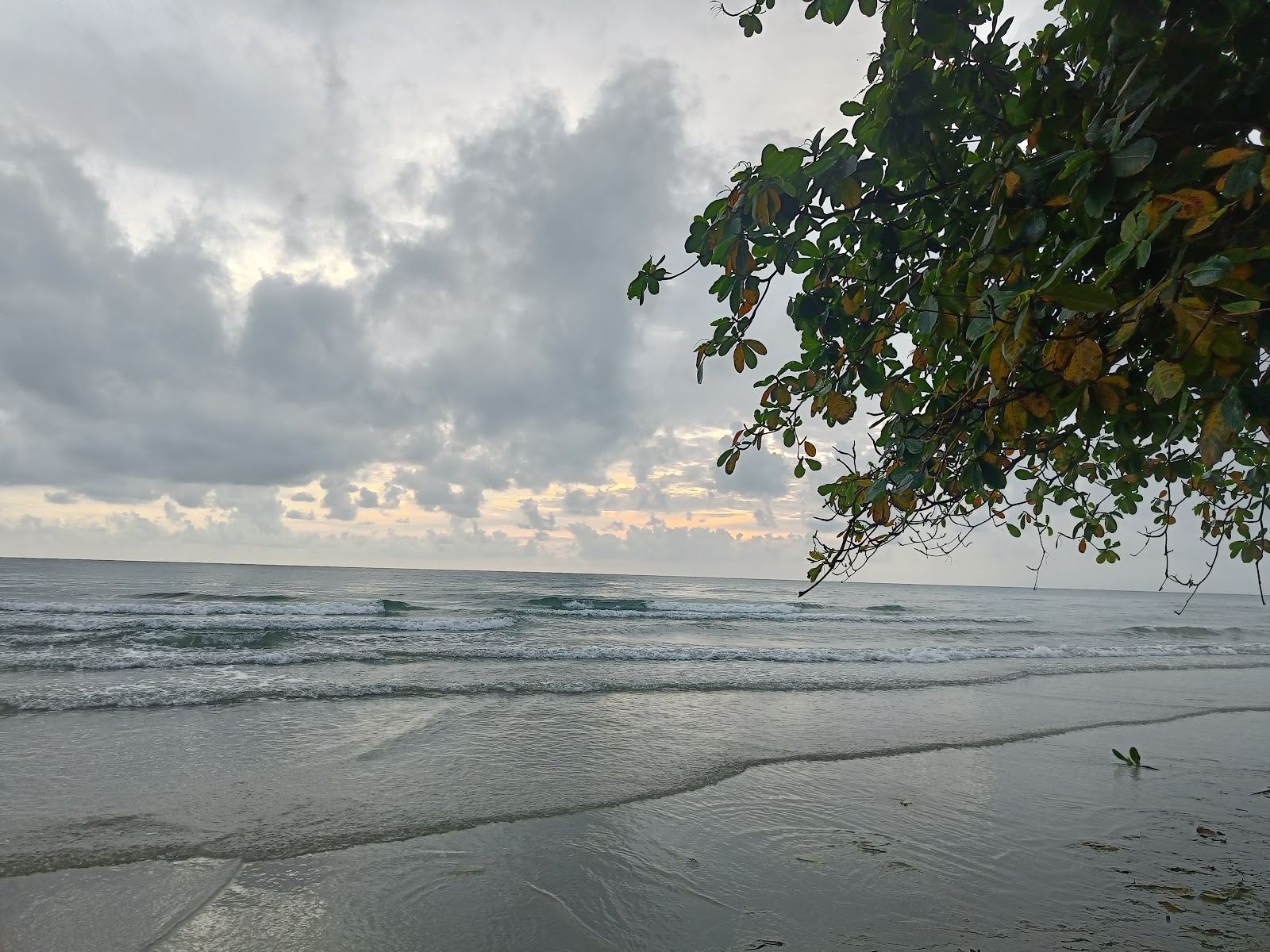 A broad, gentle stretch of west coast sand on Koh Chang with calm shallow water for children in Thailand