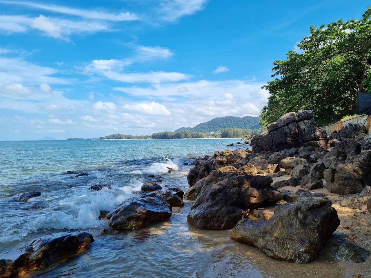 Soft sand and calm water in the sheltered cove at Relax Bay on Koh Lanta
