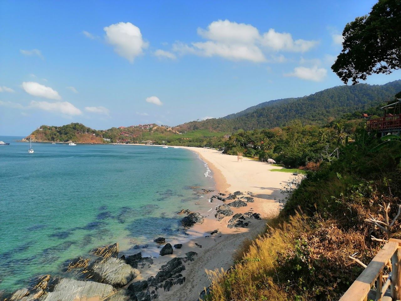 Quiet jungle framed cove and turquoise water at Bamboo Bay in the wild south of Koh Lanta