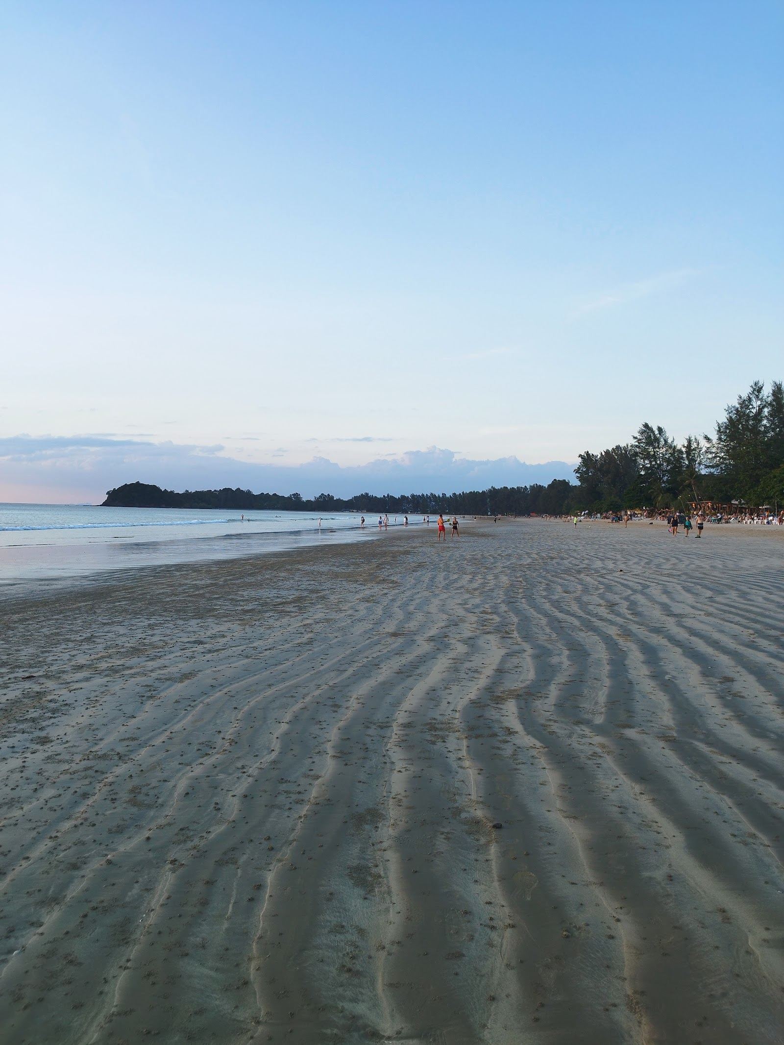 Longtail boats and calm clear water off a Koh Lanta beach