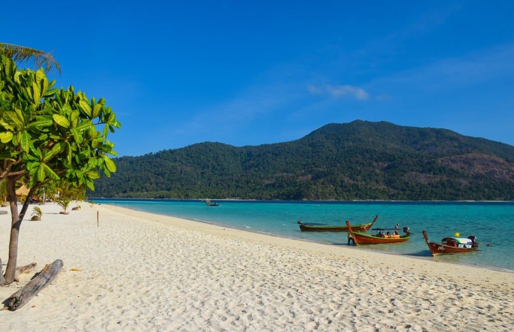Pale sand and clear shallows along Sunrise Beach on Koh Lipe in Thailand