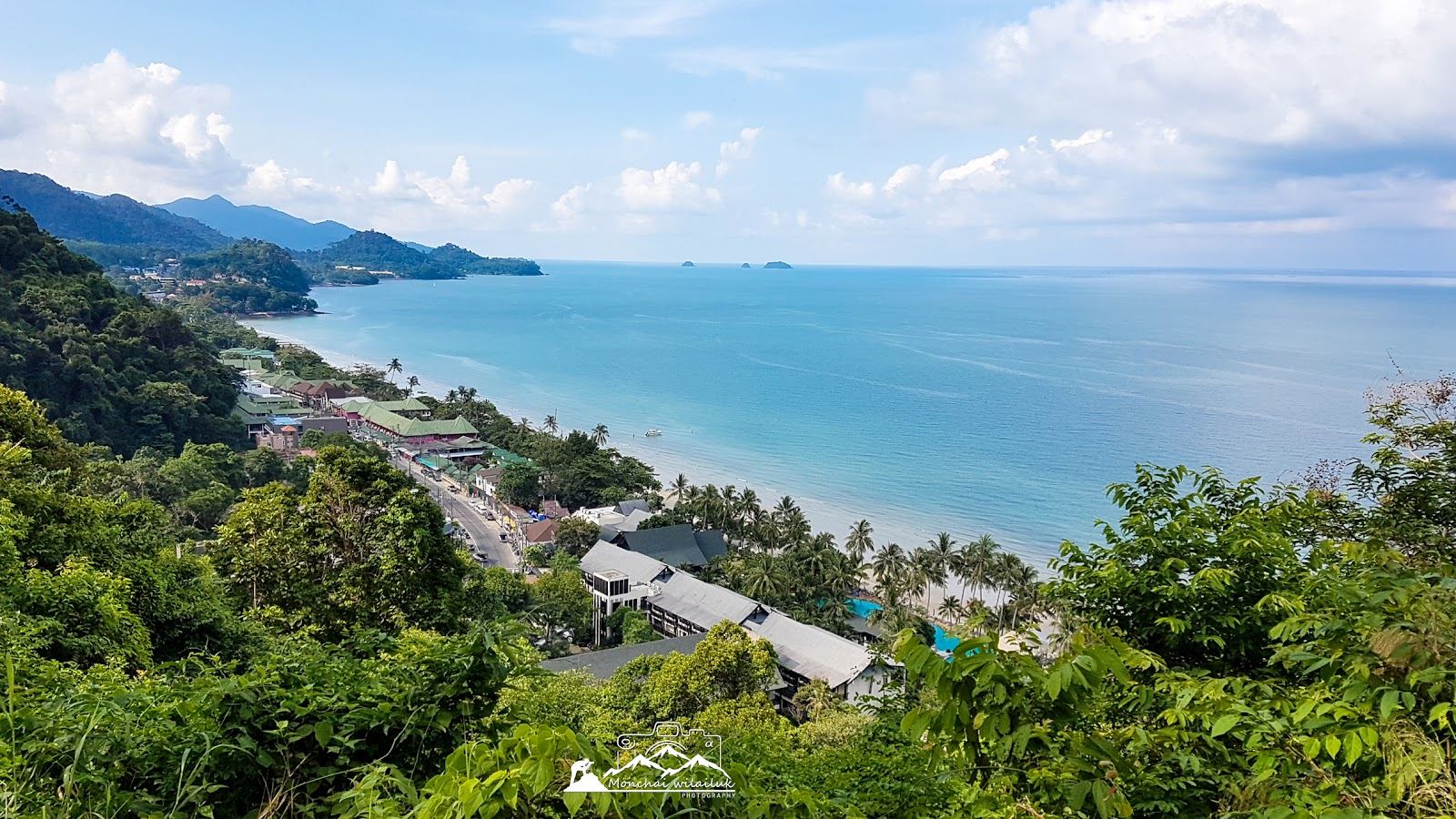 The vast white sand and clear water of the beach on Koh Adang backed by pine forest across from Koh Lipe