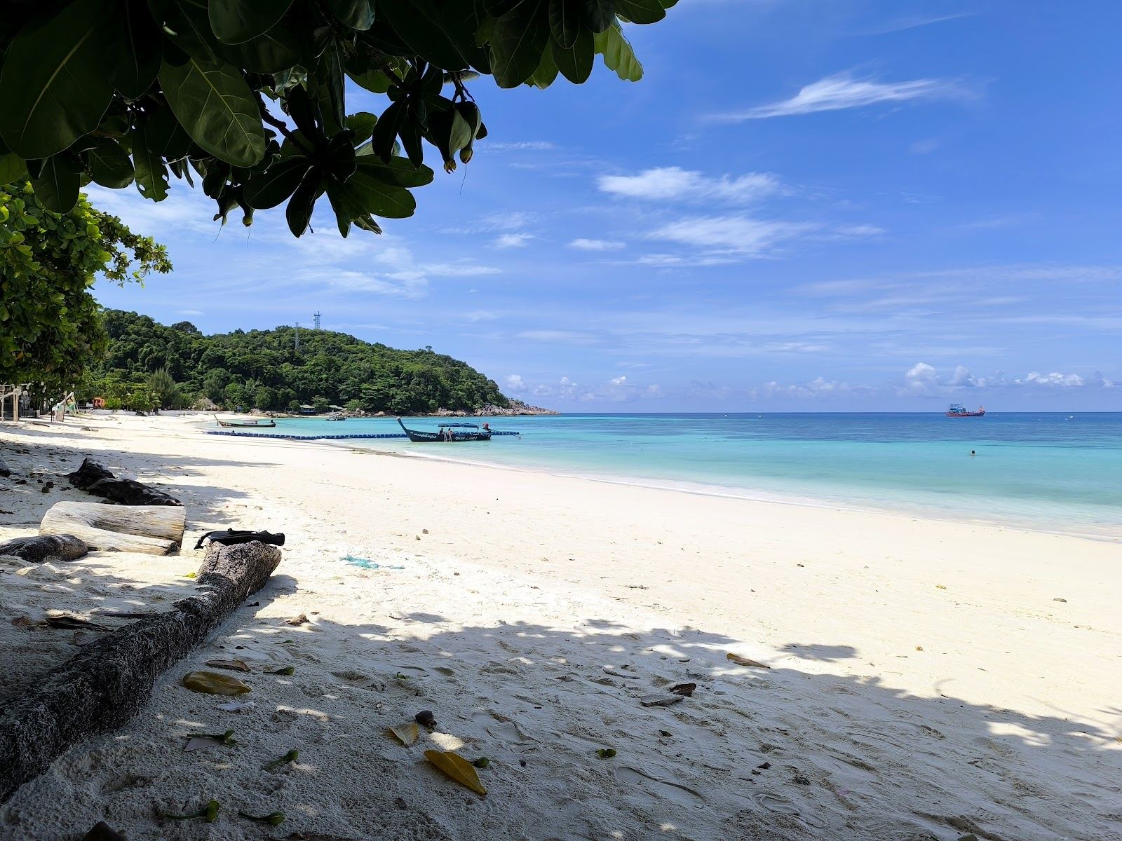 Soft white sand and clear shallow water along Pattaya Beach, the arrival and nightlife beach of Koh Lipe