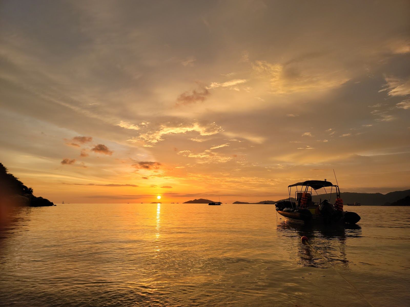 The sun low over the sea off Sunset Beach on the west side of Koh Lipe