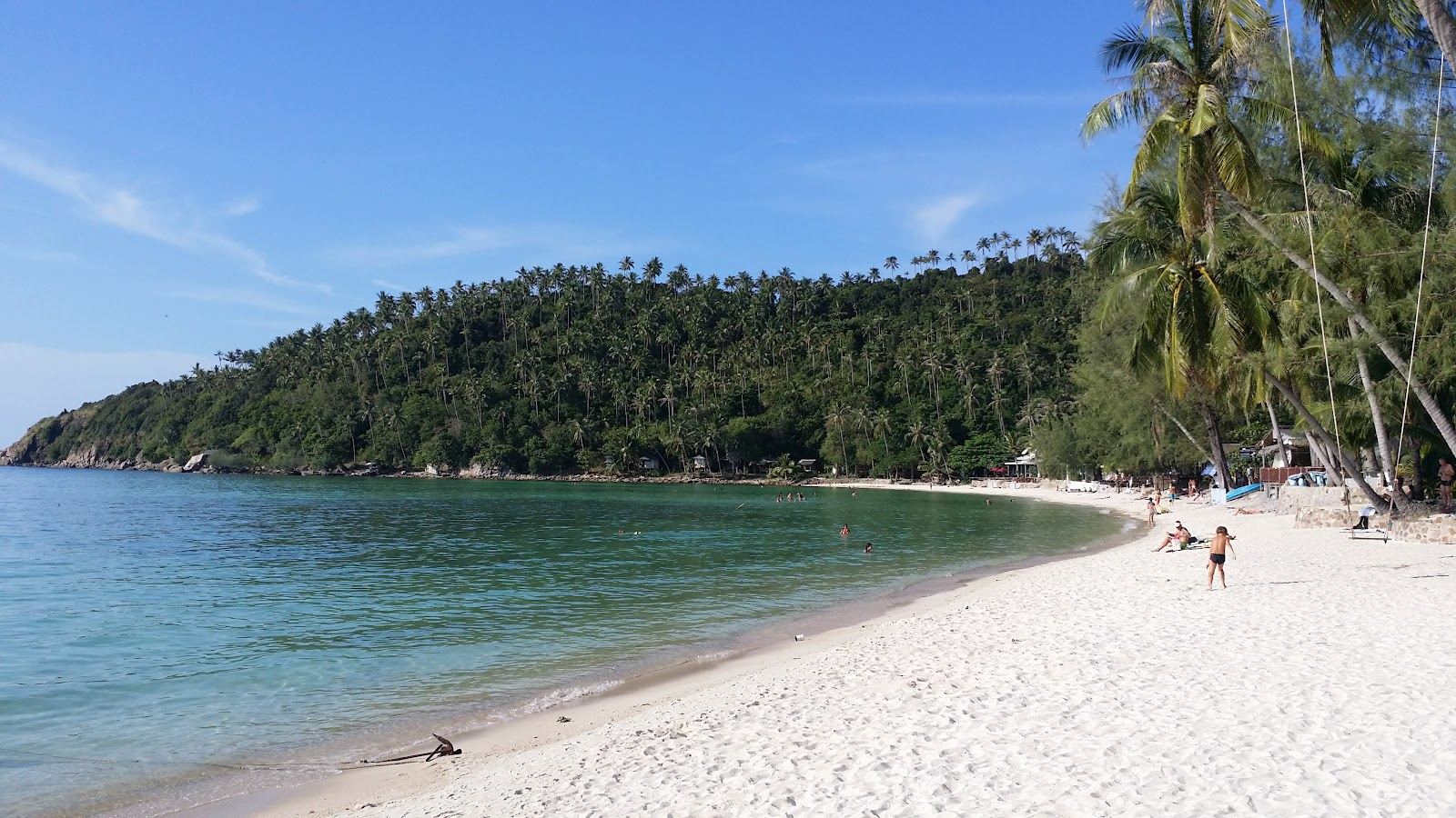 Flat, clear water over pale sand in a sheltered bay on Koh Phangan