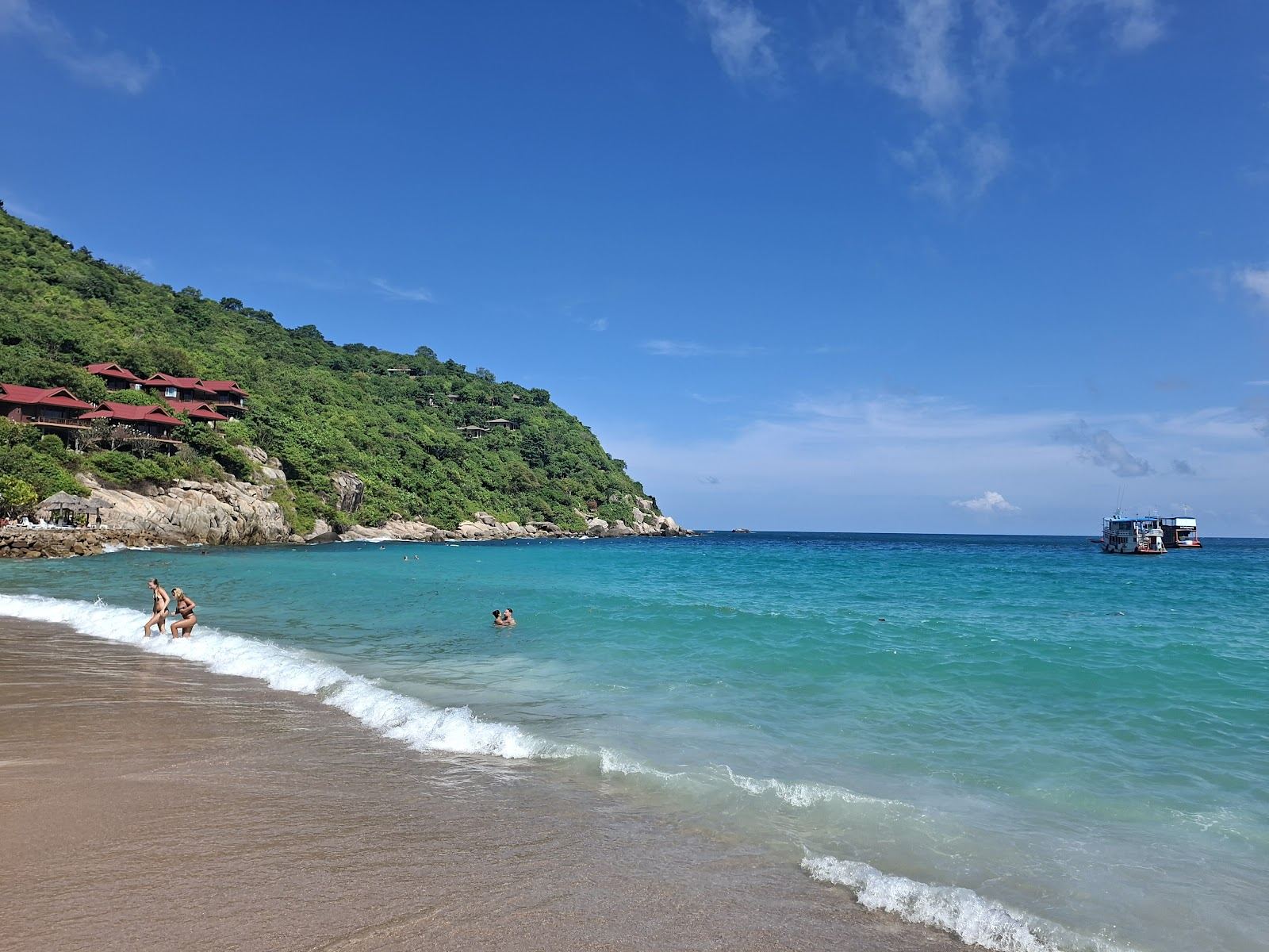 Calm clear water in the sheltered curve of Aow Leuk bay on the east coast of Koh Tao