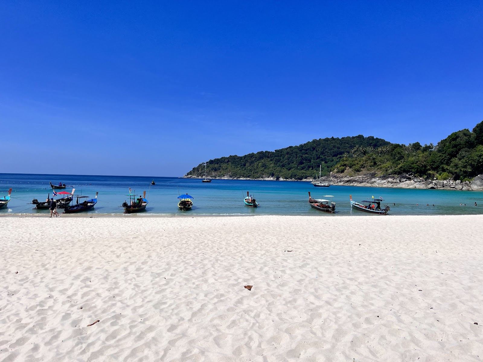 A quiet secluded cove of pale sand and clear water at the southern tip of Koh Tao