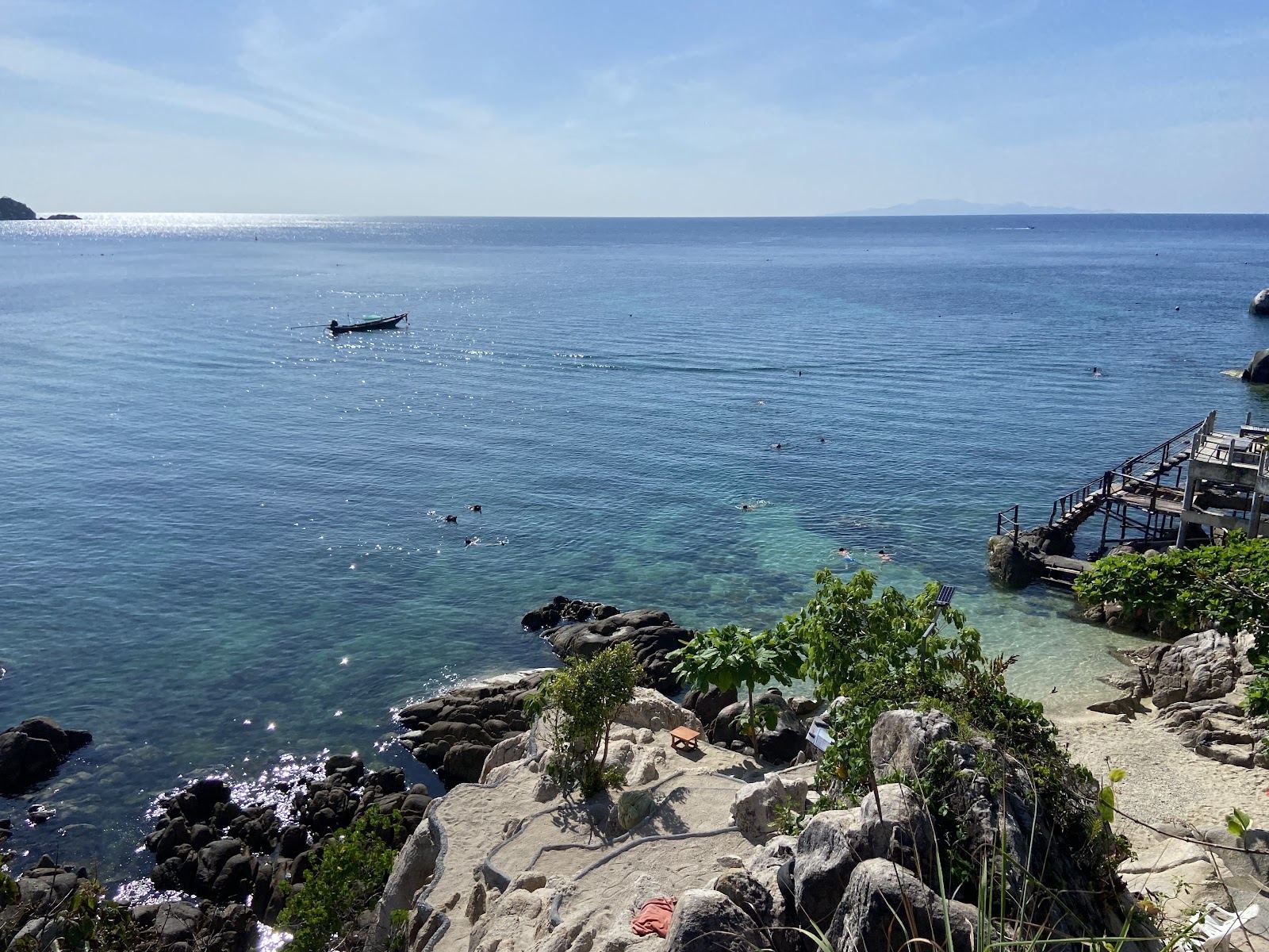 The clear water, rocky headlands and small sandy cove of Shark Bay on the south coast of Koh Tao in Thailand