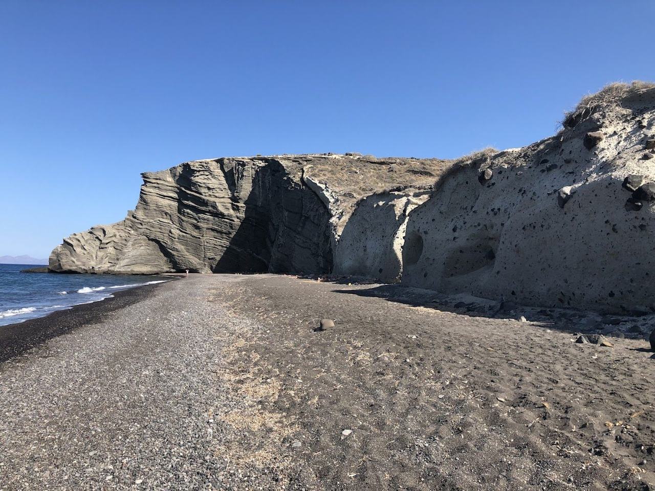 The wild undeveloped shoreline and cliffs at Koloumbos Beach in Santorini