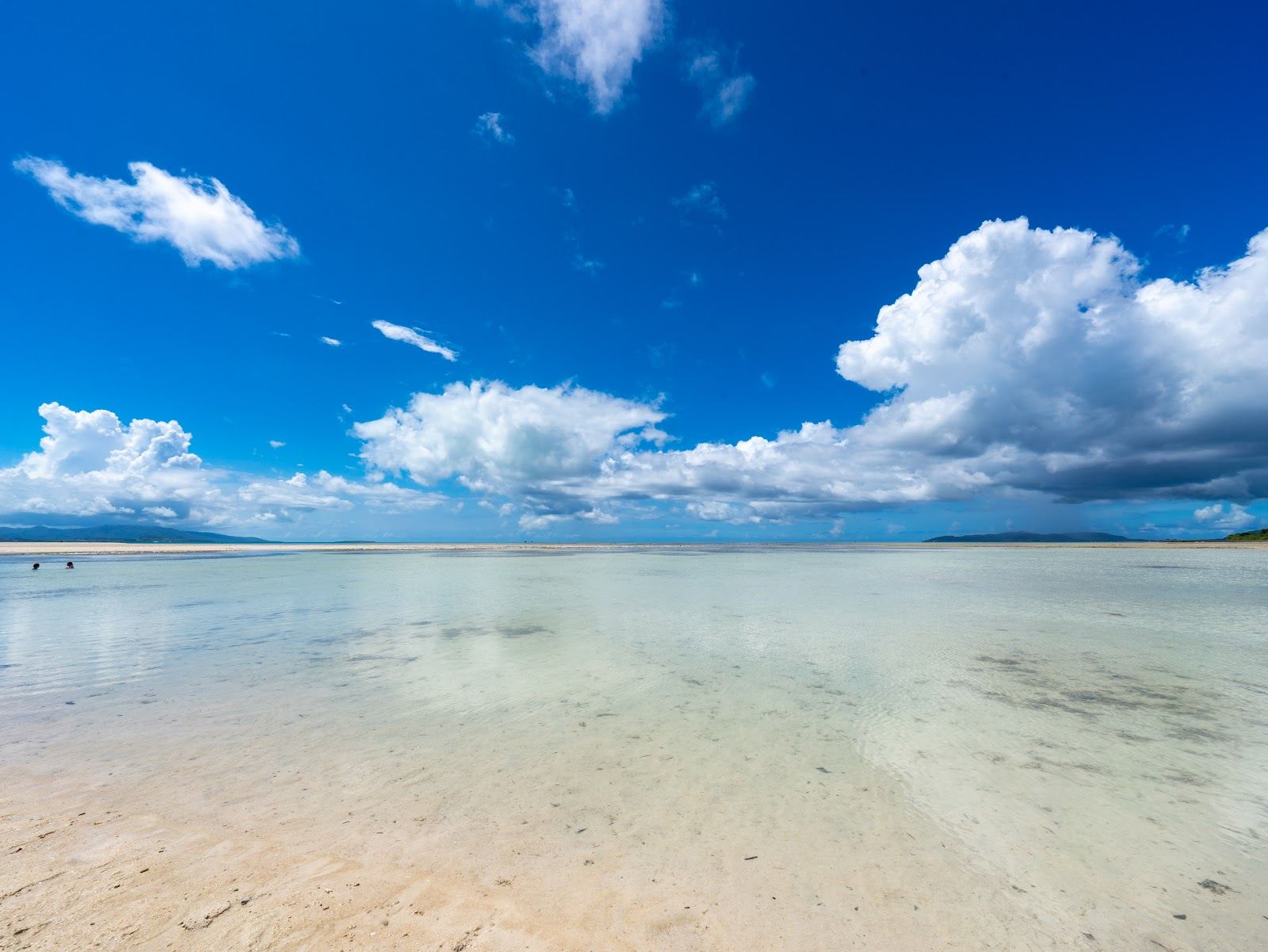 The shallow turquoise lagoon and pale coral sand of Kondoi Beach on Taketomi, Okinawa