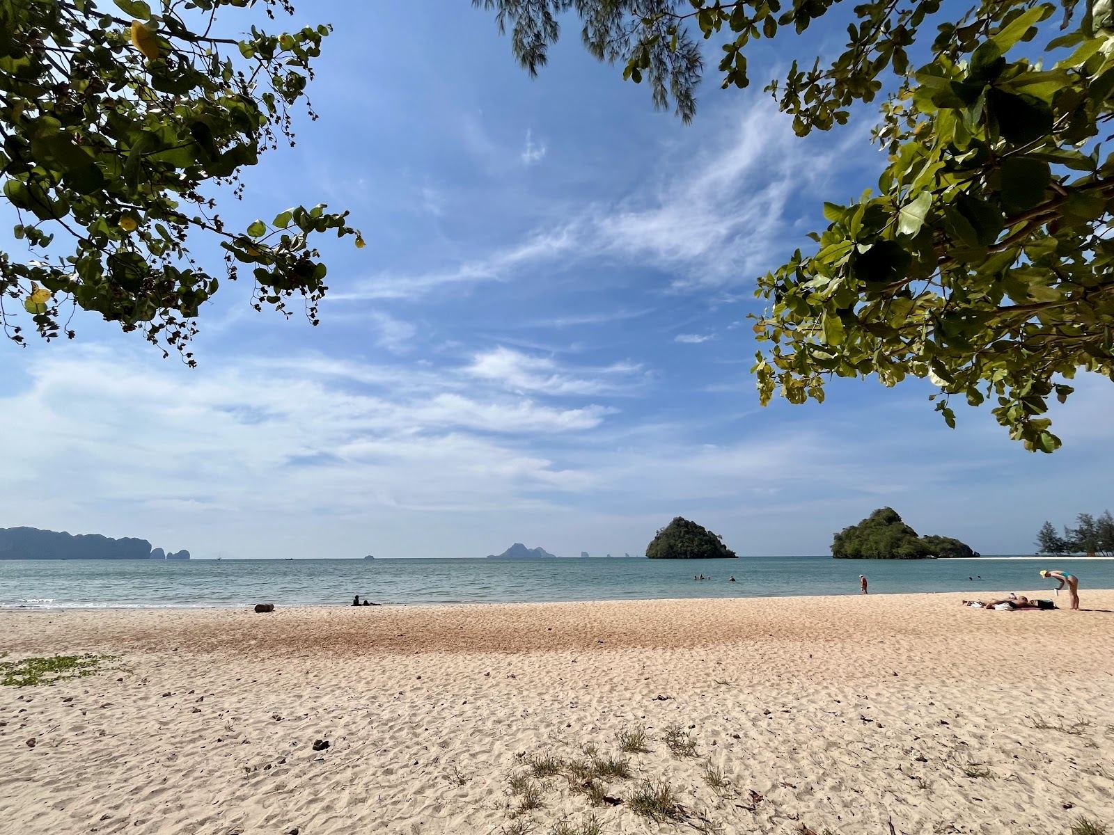 The long free public sand at Nopparat Thara beach near Ao Nang in Krabi with longtail boats offshore