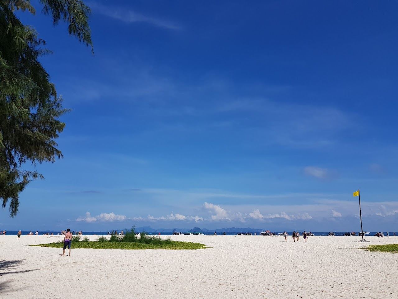 Pale sand and clear shallow water at quiet Bamboo Island near Krabi