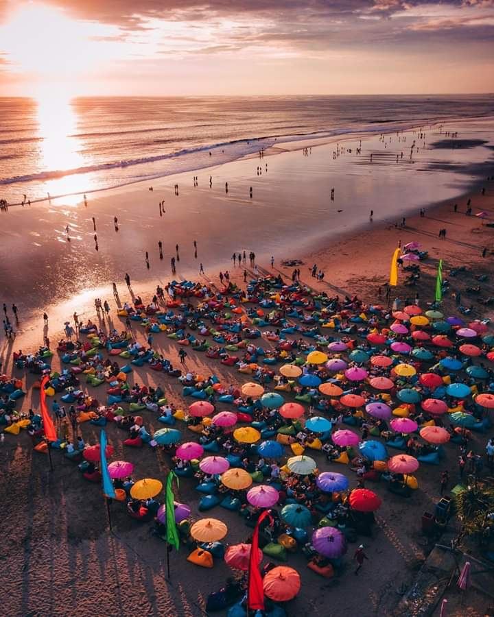 Wide grey gold sand and surf on Seminyak beach at Kayu Aya in Bali near sunset