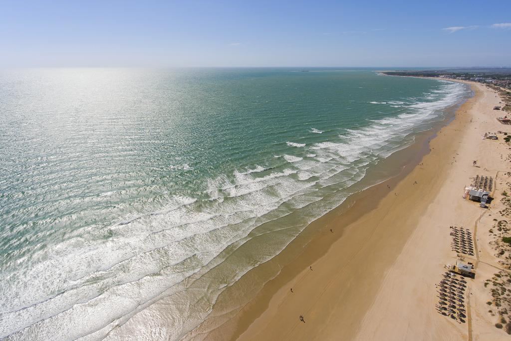 Wide golden sand and gentle Atlantic water at La Barrosa beach near Chiclana de la Frontera on the Costa de la Luz