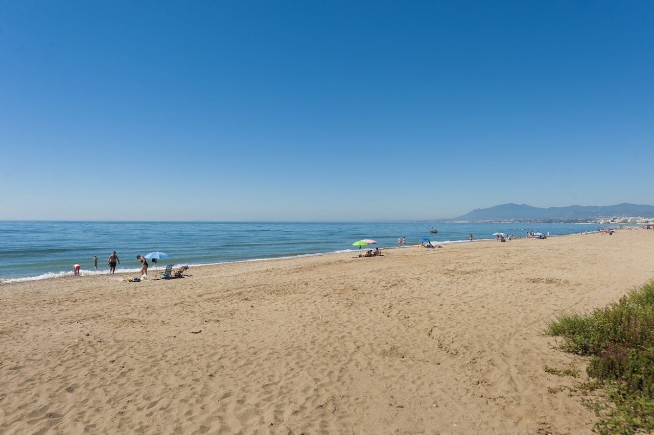 Golden sand and calm Mediterranean water along the Los Monteros beach east of Marbella