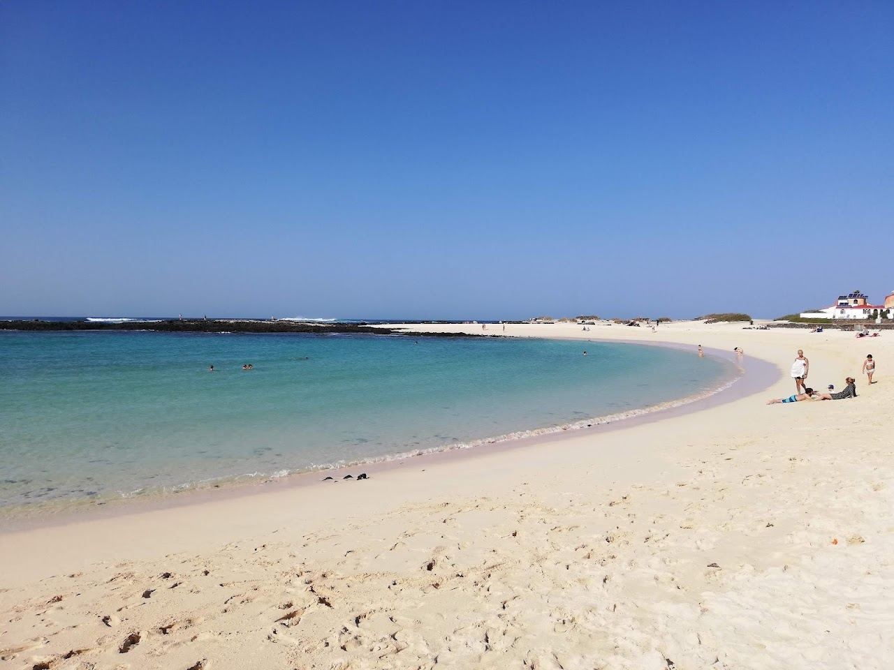 Sheltered shell shaped bay with calm turquoise water at Playa de la Concha in El Cotillo, Fuerteventura