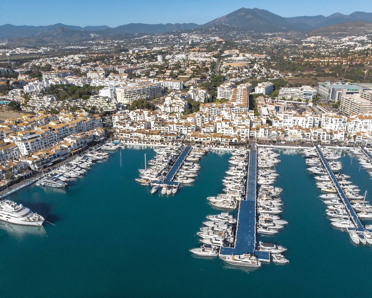 The sand and calm water of Puerto Banus beach beside the marina in Marbella