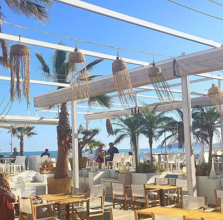 Tables and parasols on the seafront terrace at La Siesta in Javea