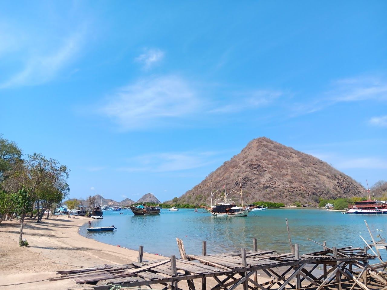 Calm shallow water and white sand at Waecicu Beach near Labuan Bajo