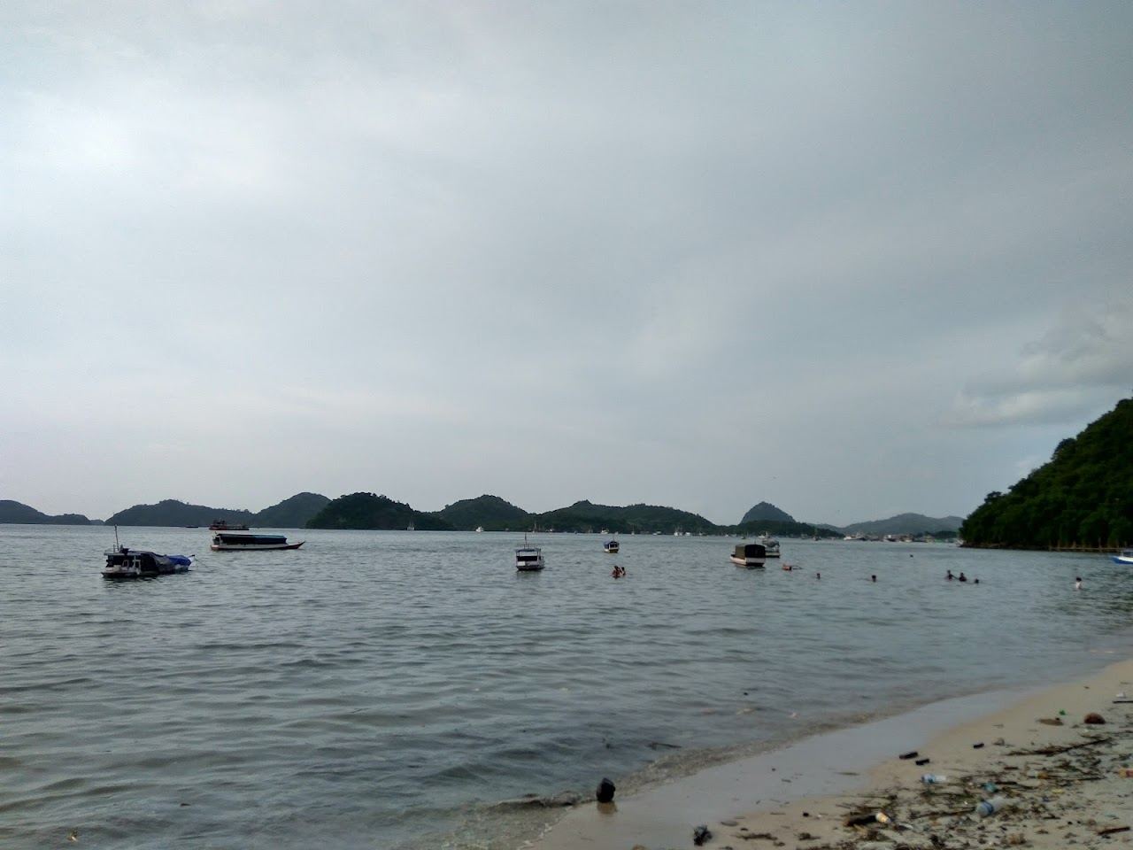 Golden sunset over the harbour and islands from a beach near Labuan Bajo