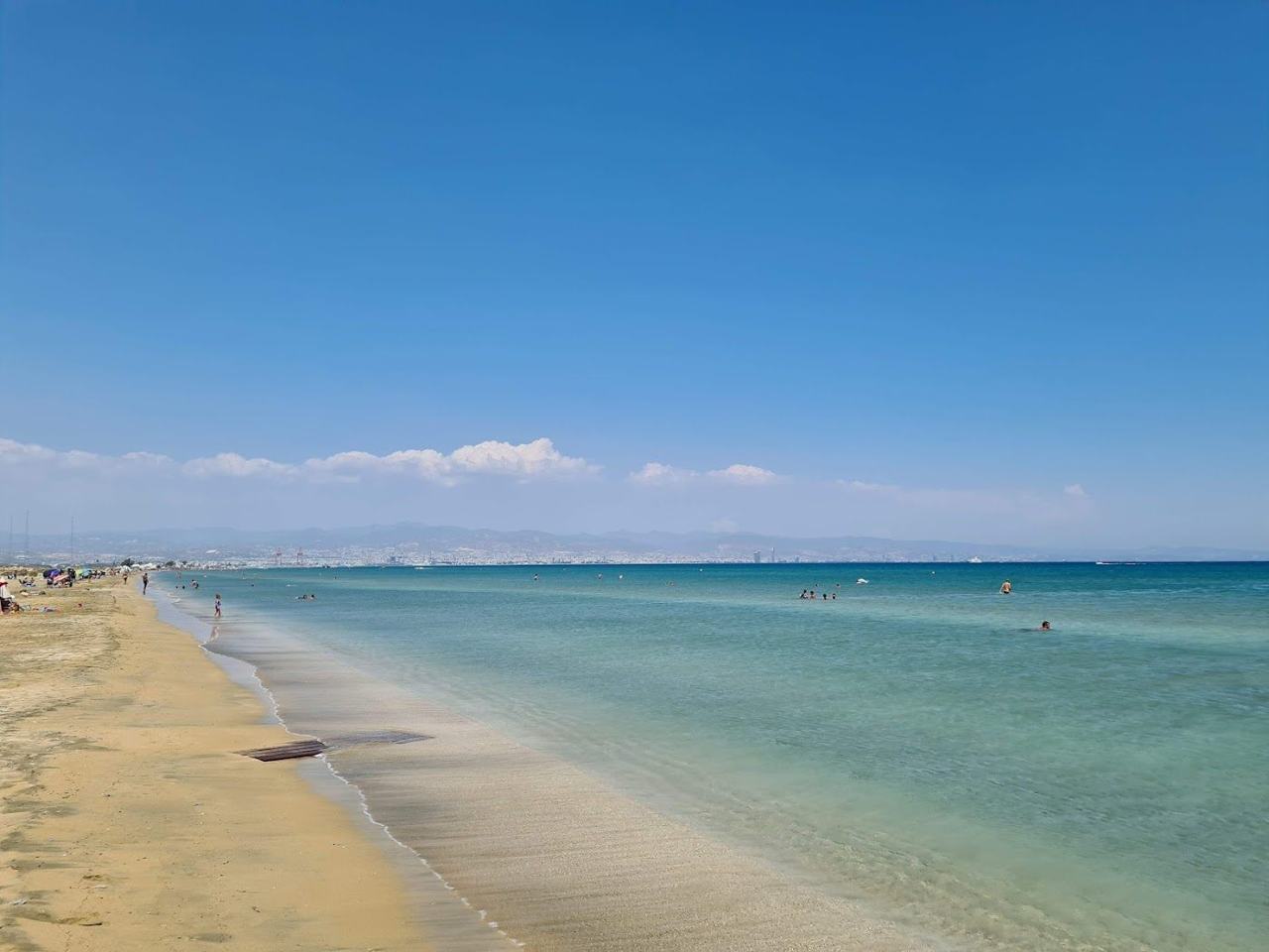 Straight open shoreline with shallow water and a beach bar at Lady's Mile on the Akrotiri peninsula in Cyprus