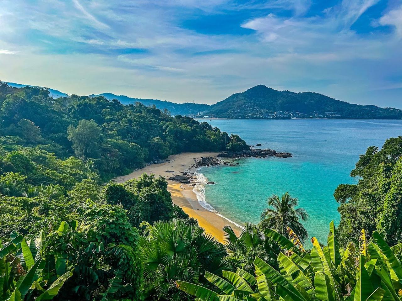 Giant boulders framing a small turquoise cove at Laem Singh Beach in Phuket